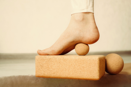 Foot on cork massage ball for plantar fascia