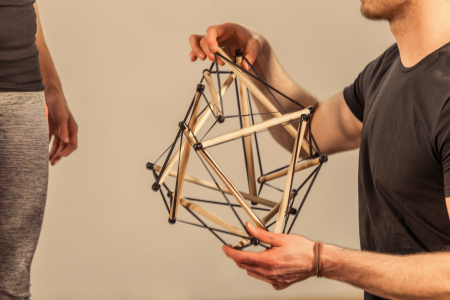 Person holding a model of Tensegrity Icosahedron in his hands