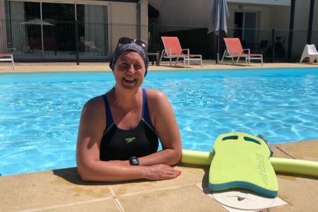 woman in a pool, smiling